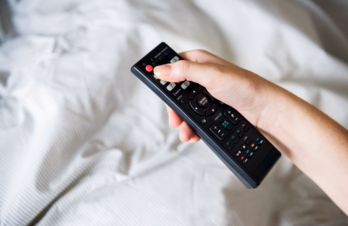 Persona configurando un televisor inteligente con el control remoto